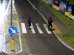 wizerunek dwóch osób ubranych na czarno od stóp do głów, z boku spodni na łydce białe wstawki (napis)